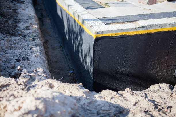 Professional Basement Waterproofing technician working in Oaks, PA